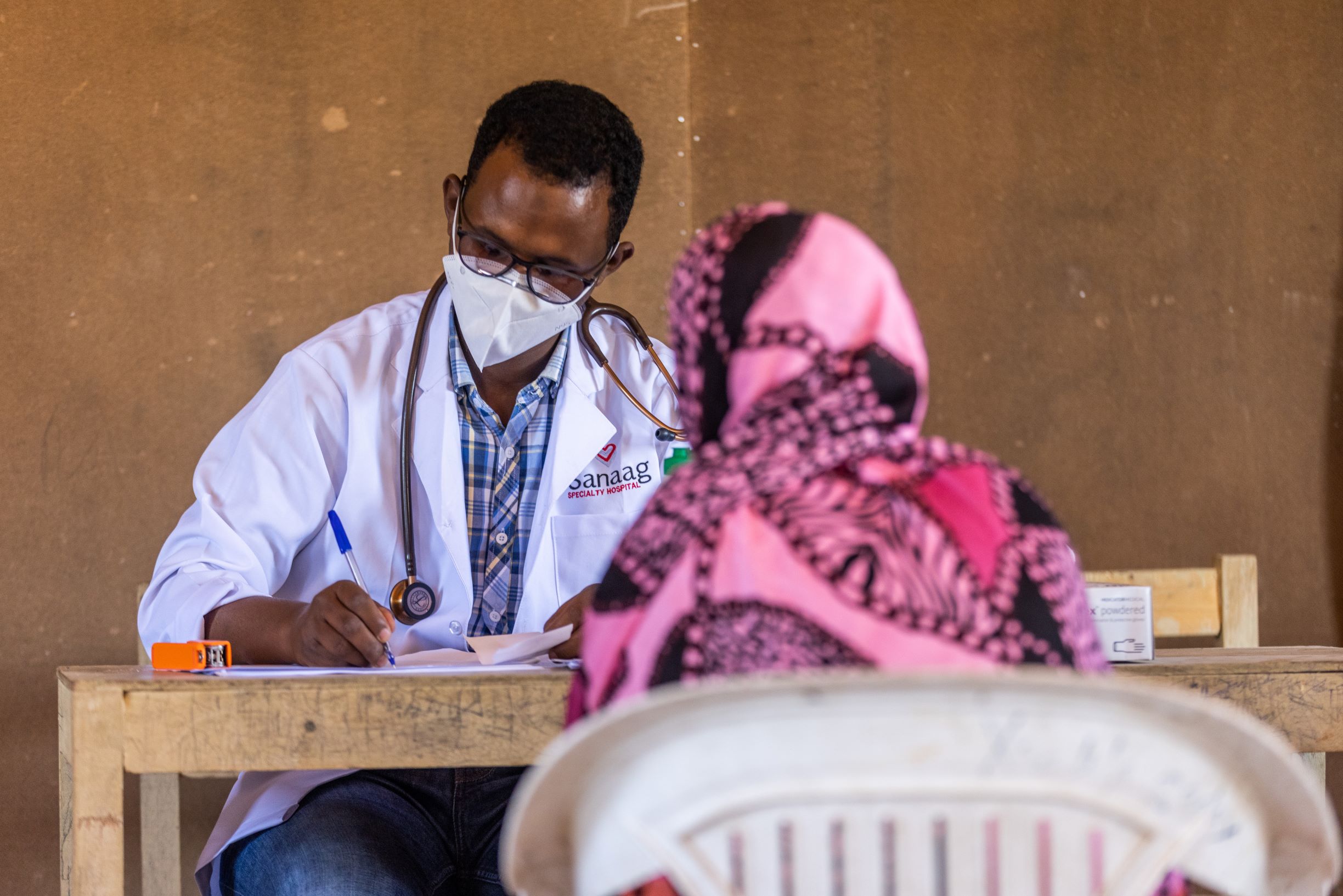 A local doctor conducts a visit with a community member.